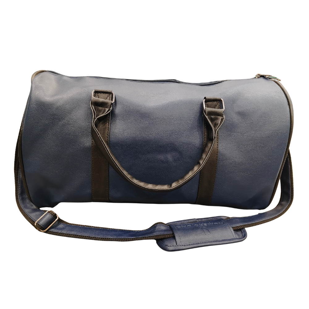 Navy blue faux leather duffle bag with black handles and shoulder strap isolated on white background