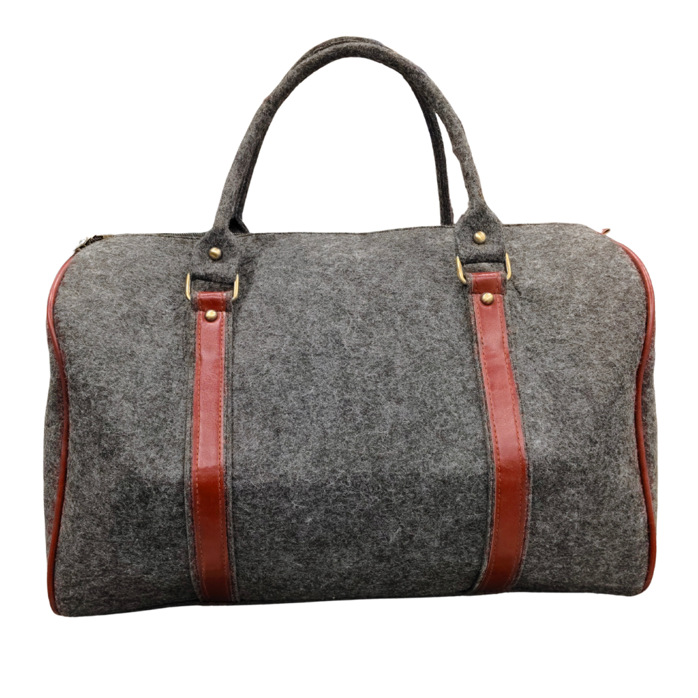 A charcoal grey felt weekend duffel bag with brown faux leather straps and metal hardware on a white background.