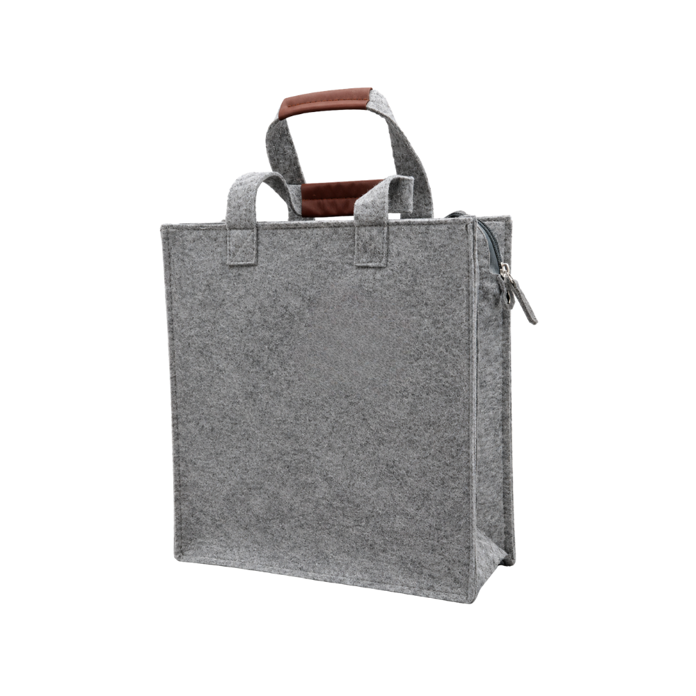 A grey felt tote bag with brown faux-leather handle grips and a zippered top, isolated on a white background.