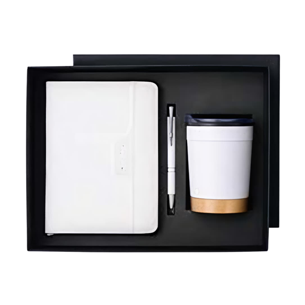 A white notebook, white pen, and white travel mug with a wood-tone base arranged in a black gift box.