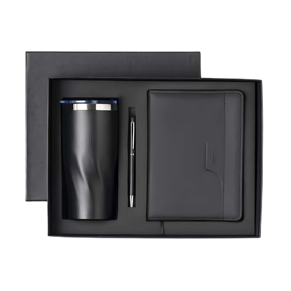 Top-down view of an executive gift set in a charcoal box containing a matte black tumbler, a pen, and a notebook.