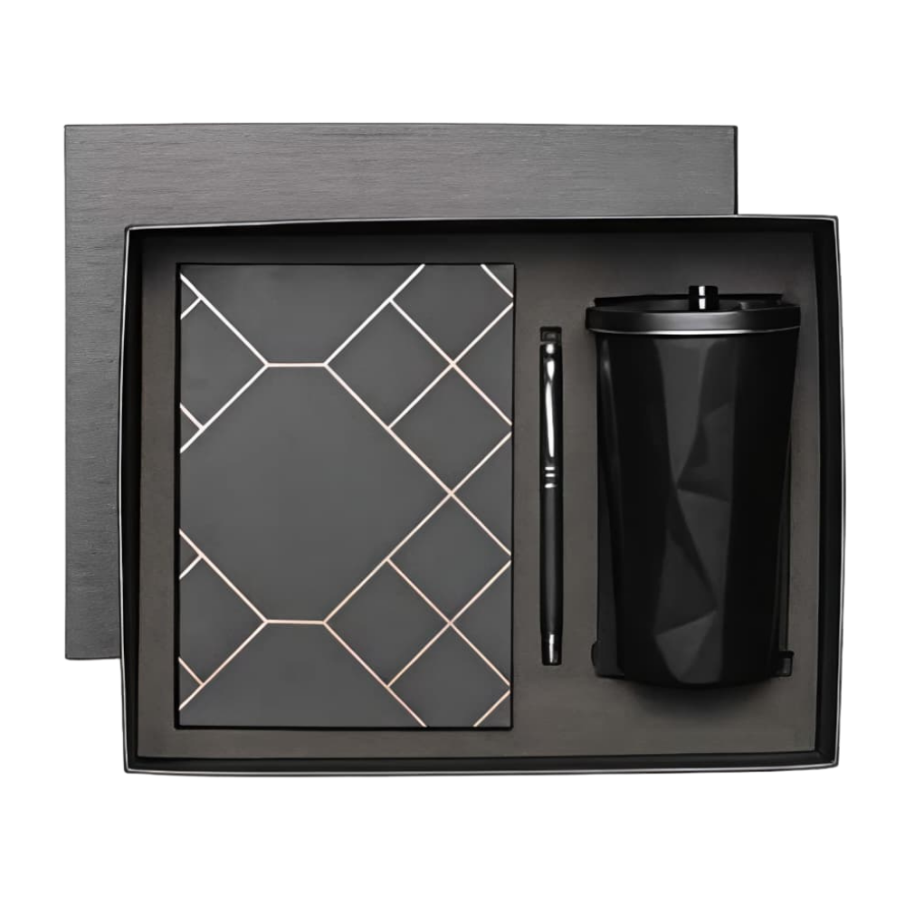 Top-down view of a black executive gift set containing a geometric patterned notebook, a metal pen, and a faceted tumbler in a presentation box.