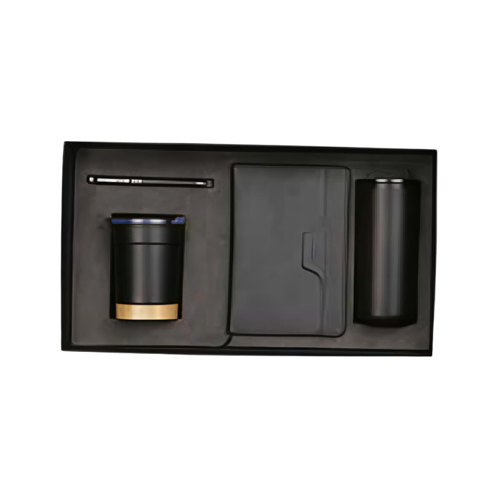 A black executive gift set in a presentation box containing a vacuum-insulated tumbler, a notebook, and a pen.
