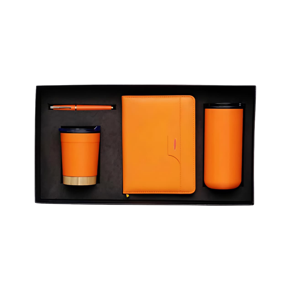 A professional executive gift set in a black box, containing an orange notebook, orange ballpoint pen, and an orange vacuum-insulated tumbler with a metallic base.