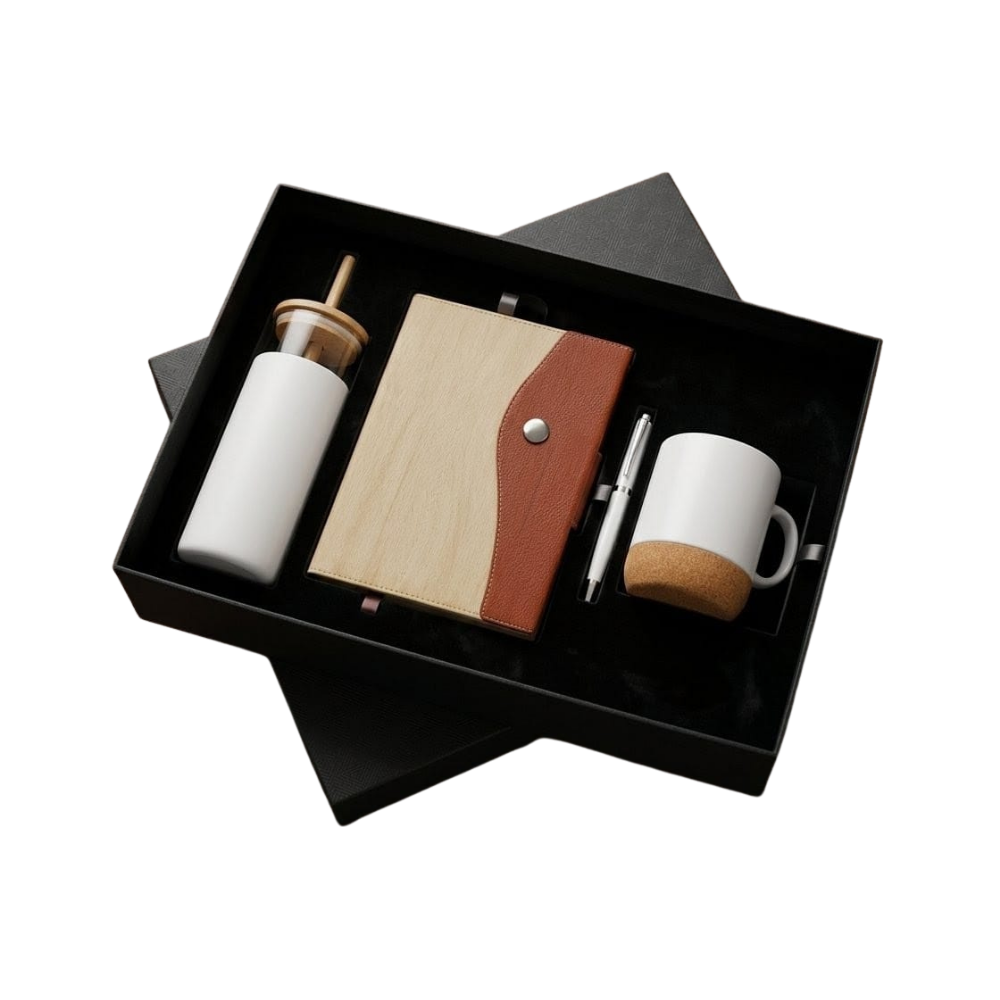 A premium corporate gift set in a black box containing a bamboo-accented notebook, white bottle, cork-base mug, and a silver pen.