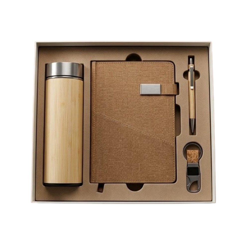 A professional corporate gift set in a tan box containing a bamboo bottle, a brown linen notebook, a bamboo pen, and a cork keychain.