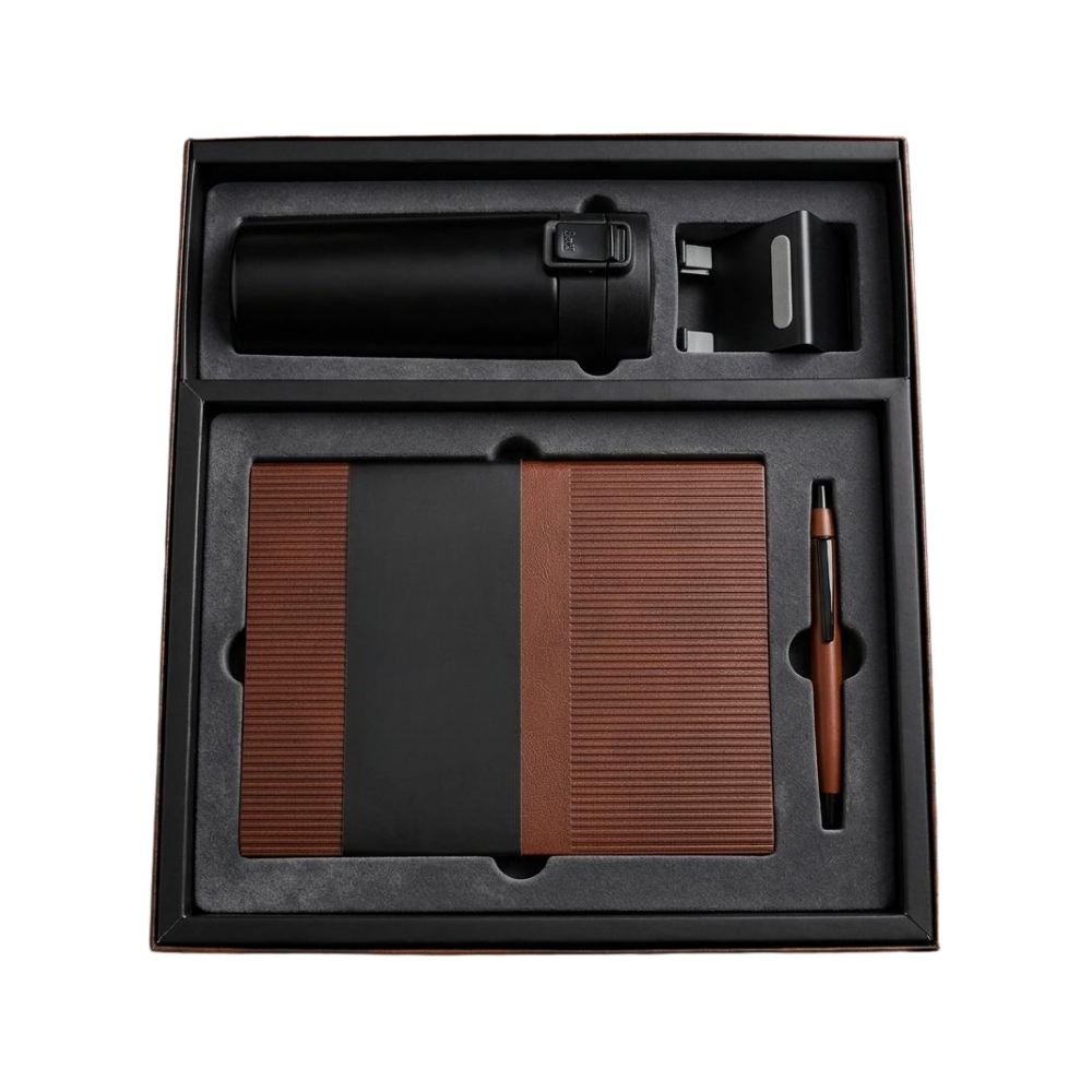 Top-down view of a black executive gift box containing a vacuum bottle, a brown and black notebook, and a matching pen.
