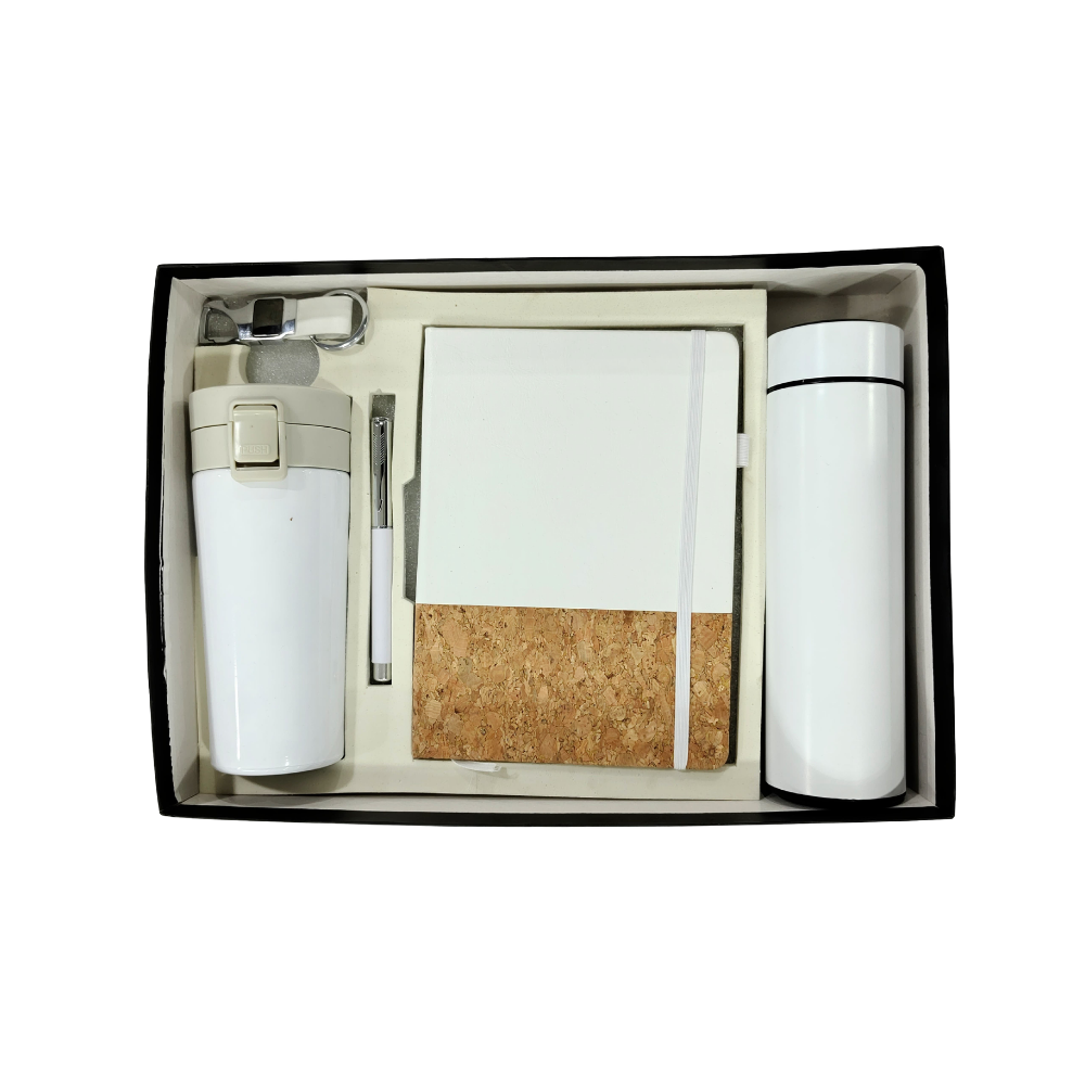 A premium executive gift set in a black box containing a white vacuum bottle, a white travel mug, a white and cork notebook, a pen, and a keychain.