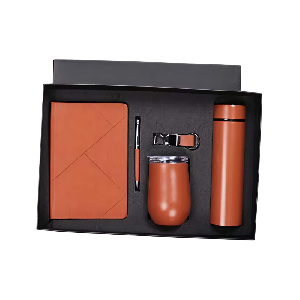 A 4-piece rose gold corporate gift set inside a black presentation box, containing a notebook, pen, keychain, stemless tumbler, and vacuum bottle.