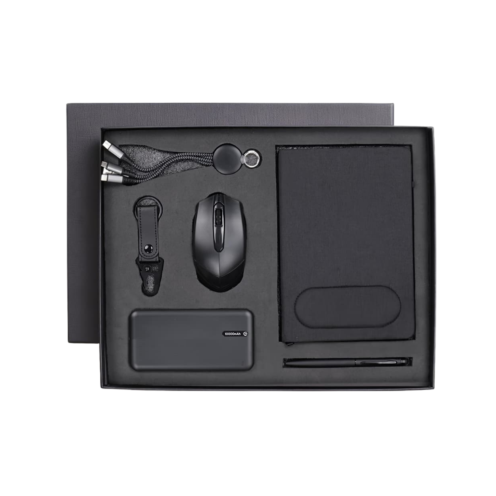 Top-down view of an executive gift set in a charcoal box containing a power bank, wireless mouse, notebook, pen, and charging cable.