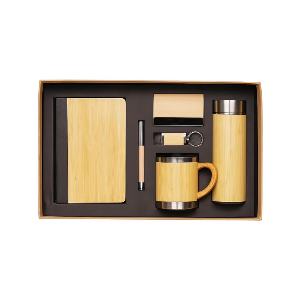 Top-down view of a bamboo-themed corporate gift set in a black box, including a notebook, pen, card holder, keychain, and mug.