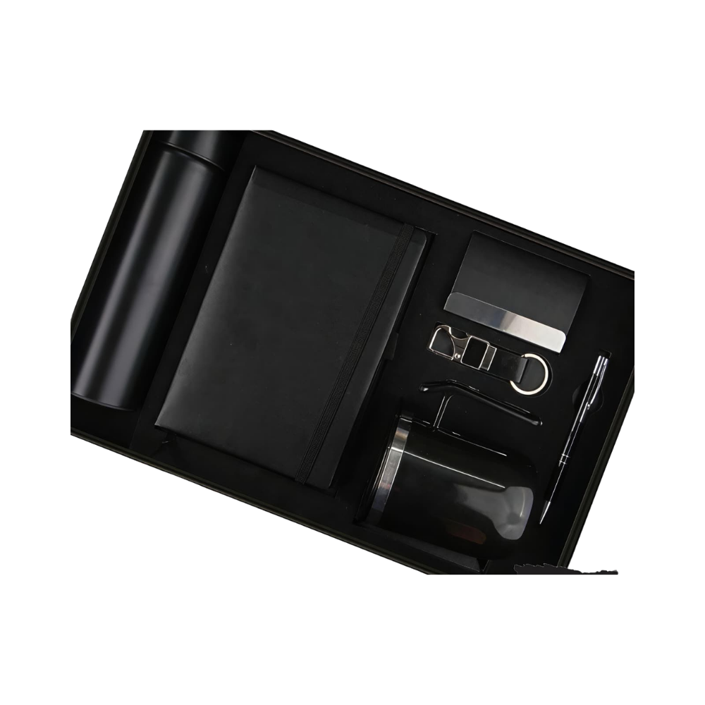 A 5-piece executive gift set in a black presentation box, containing a matte black bottle, notebook, pen, business card holder, and keychain.