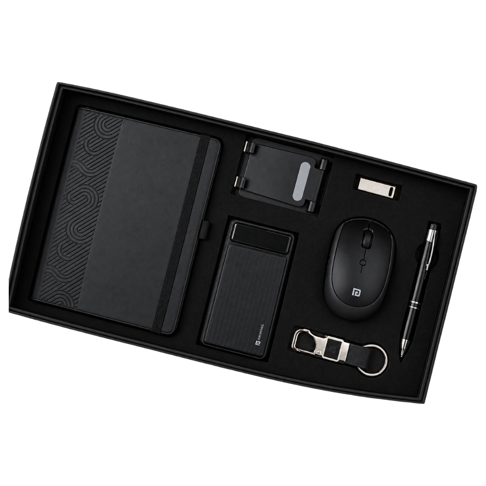 Top-down view of a 6-piece executive gift set in a black box, including a notebook, power bank, mouse, phone stand, USB, and keychain.