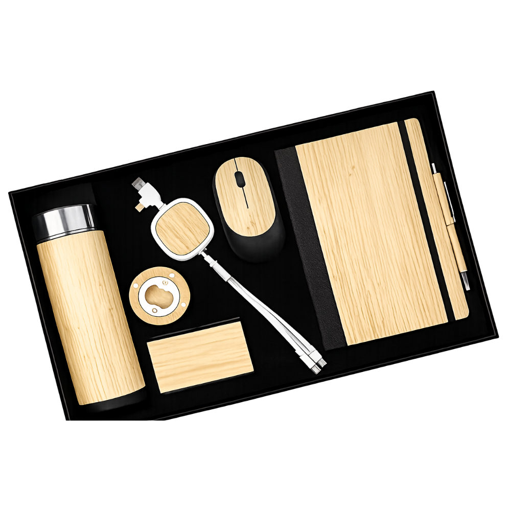 Top-down view of a black gift box containing a bamboo-themed office and tech set including a bottle, mouse, notebook, pen, and cable.