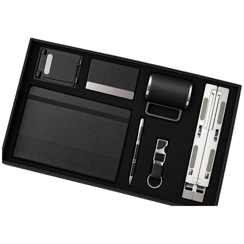 A premium 6-piece executive gift set in a black box, including a notebook, laptop stand, mug, pen, card holder, and keychain.