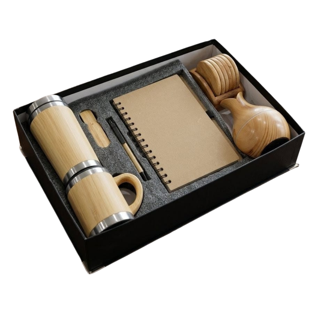 A premium eco-friendly corporate gift set in a black box, featuring a bamboo bottle, mug, notebook, pen, and wooden coasters.